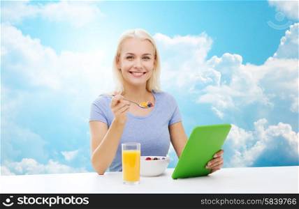 healthy eating, dieting and people concept - smiling young woman with tablet pc computer eating breakfast over blue sky and clouds background