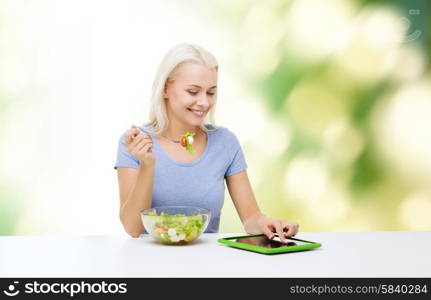 healthy eating, dieting and people concept - smiling young woman with tablet pc computer eating vegetable salad over green natural background