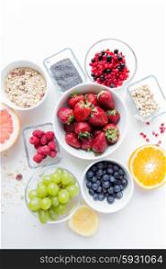 healthy eating, dieting, vegetarian food and people concept - close up of fruits and berries in bowl on table