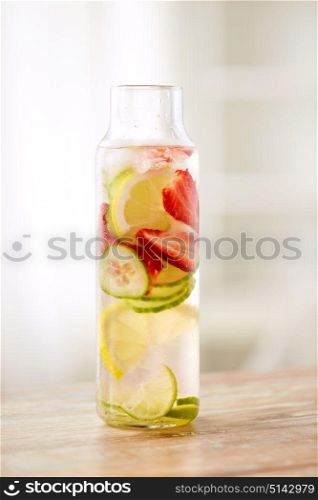 healthy eating, drinks and detox concept - close up of fruit water or ice tea in glass bottle. close up of fruit water in glass bottle