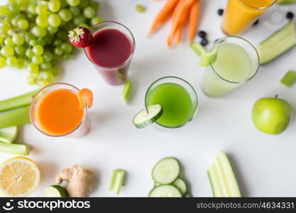 healthy eating, drinks, diet and detox concept - close up of glasses with different fruit or vegetable juices and food on table