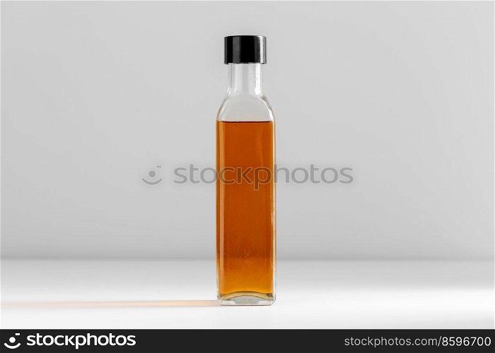 healthy eating, food and culinary concept - close up of olive oil in glass bottle on table. close up of olive oil in glass bottle on table