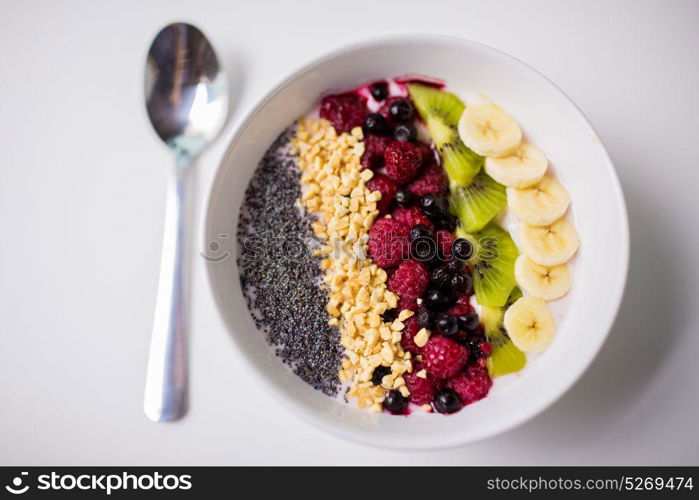 healthy eating, food and diet concept - bowl of yogurt with fruits and seeds. bowl of yogurt with fruits and seeds