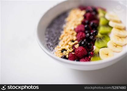 healthy eating, food and diet concept - bowl of yogurt with fruits and seeds. bowl of yogurt with fruits and seeds
