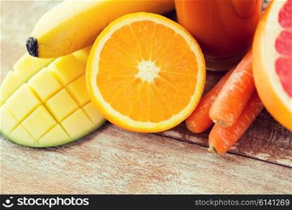 healthy eating, food and diet concept - close up of fresh fruits and juice glass on table