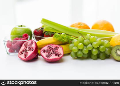 healthy eating, food and diet concept- close up of fresh ripe fruits and berries on table