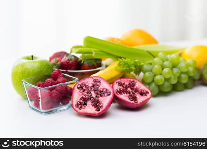 healthy eating, food and diet concept- close up of fresh ripe fruits and berries on table