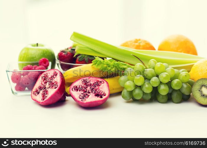 healthy eating, food and diet concept- close up of fresh ripe fruits and berries on table