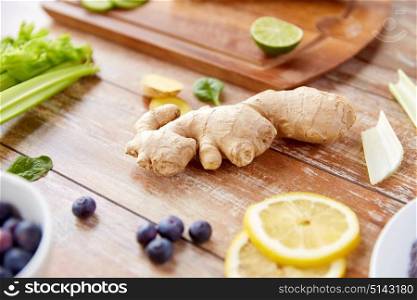 healthy eating, food and diet concept - ginger with fruits, berries and vegetables on table. ginger, fruits, berries and vegetables on table