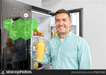 healthy eating, food and diet concept - happy smiling middle-aged man taking bottle of orange juice from fridge at home kitchen over nutritional value chart. man taking juice from fridge at home kitchen