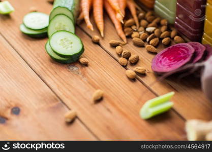 healthy eating, food, cooking, diet and vegetarian concept - different vegetables and almond nuts on wooden table