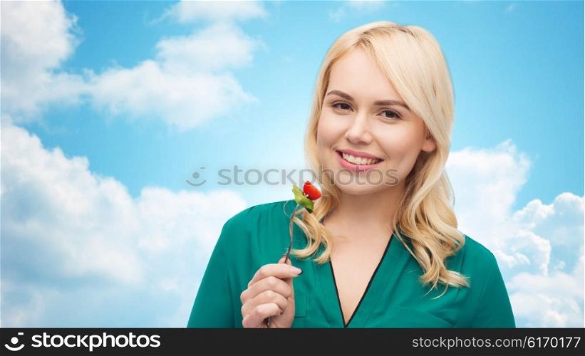 healthy eating, food, diet and people concept - smiling young woman eating vegetable salad with fork over blue sky and clouds background