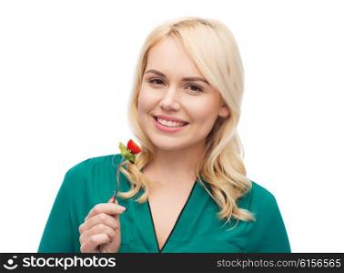 healthy eating, food, diet and people concept - smiling young woman eating vegetable salad with fork