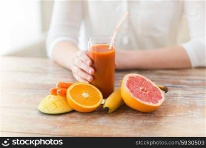 healthy eating, food, dieting and people concept - close up of woman hands with fruits and fresh juice sitting at table