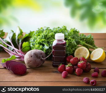 healthy eating, food, dieting and vegetarian concept - bottle with beetroot juice, fruits and vegetables on wooden table over green natural background. bottle with beetroot juice, fruits and vegetables. bottle with beetroot juice, fruits and vegetables