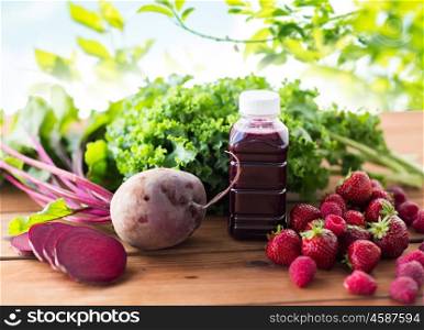 healthy eating, food, dieting and vegetarian concept - bottle with beetroot juice, fruits and vegetables on wooden table over green natural background