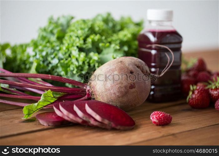 healthy eating, food, dieting and vegetarian concept - bottle with beetroot juice, fruits and vegetables on wooden table