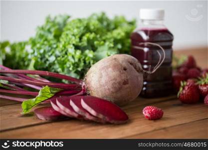 healthy eating, food, dieting and vegetarian concept - bottle with beetroot juice, fruits and vegetables on wooden table
