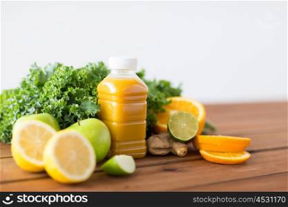 healthy eating, food, dieting and vegetarian concept - bottle with orange juice, fruits and vegetables on wooden table