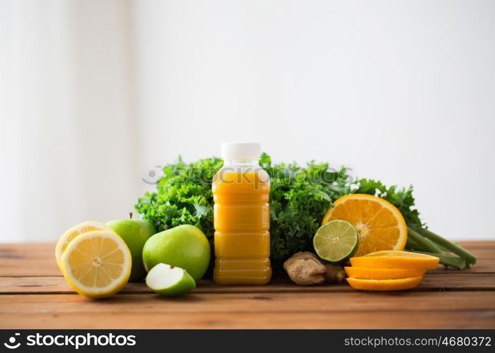 healthy eating, food, dieting and vegetarian concept - bottle with orange juice, fruits and vegetables on wooden table