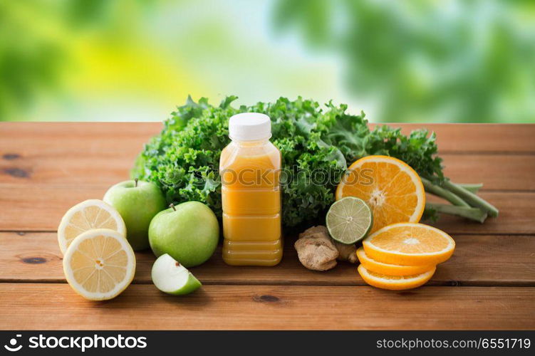 healthy eating, food, dieting and vegetarian concept - bottle with orange juice, fruits and vegetables on wooden table over green natural background. bottle with orange juice, fruits and vegetables. bottle with orange juice, fruits and vegetables