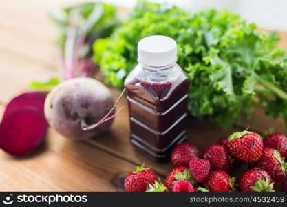 healthy eating, food, dieting and vegetarian concept - close up of bottle with beetroot juice, fruits and vegetables on wooden table