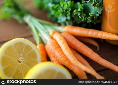 healthy eating, food, dieting and vegetarian concept - close up of carrot, lemon and lettuce