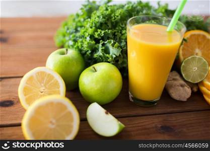 healthy eating, food, dieting and vegetarian concept - close up of glass with orange juice, fruits and vegetables on wooden table