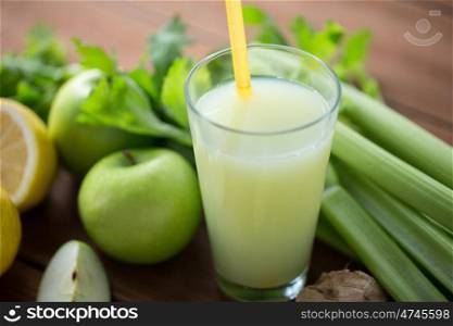 healthy eating, food, dieting and vegetarian concept - close up of glass with green juice, fruits and vegetables on wooden table