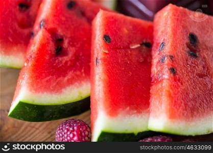 healthy eating, food, dieting and vegetarian concept - close up of watermelon slices on wooden table