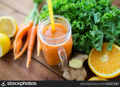 healthy eating, food, dieting and vegetarian concept - glass jug of carrot juice, fruits and vegetables on wooden table