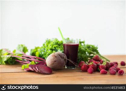 healthy eating, food, dieting and vegetarian concept - glass of beetroot juice, fruits and vegetables on wooden table