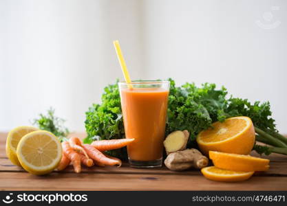 healthy eating, food, dieting and vegetarian concept - glass of carrot juice, fruits and vegetables on wooden table