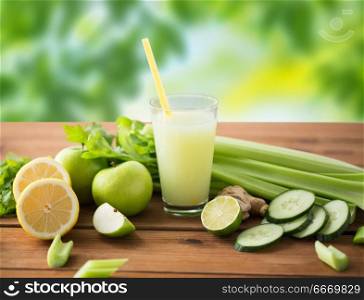 healthy eating, food, dieting and vegetarian concept - glass of green juice with fruits and vegetables on wooden table over green natural background. glass of green juice with fruits and vegetables. glass of green juice with fruits and vegetables
