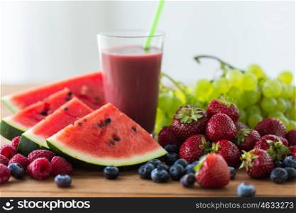 healthy eating, food, dieting and vegetarian concept - glass with fruit and berry juice or smoothie on wooden table