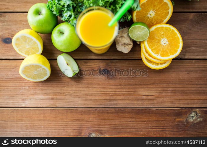 healthy eating, food, dieting and vegetarian concept - glass with orange juice, fruits and vegetables on wooden table