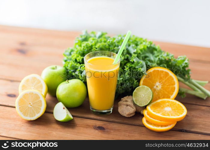 healthy eating, food, dieting and vegetarian concept - glass with orange juice, fruits and vegetables on wooden table