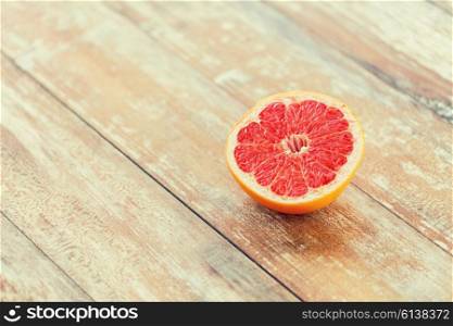 healthy eating, food, fruits and diet concept - close up of fresh juicy cut grapefruit