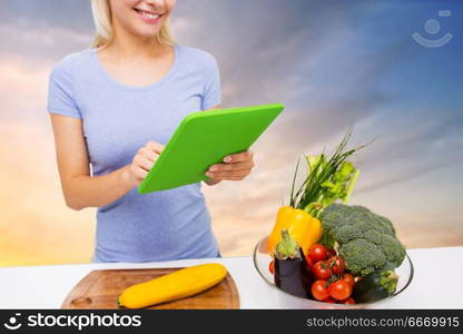 healthy eating, food, technology and people concept - close up of smiling young woman with tablet pc computer and bowl of vegetables over sky background. close up of woman with tablet pc and vegetables. close up of woman with tablet pc and vegetables