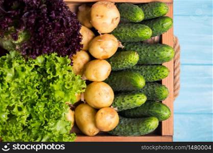 healthy eating. fresh vegetables in a tray on a blue wooden background