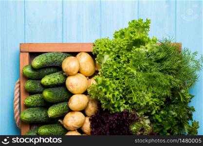 healthy eating. fresh vegetables in a tray on a blue wooden background