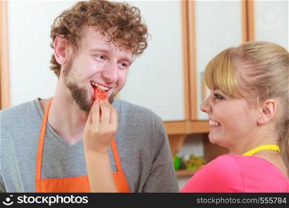 Healthy eating. happy young couple have fun in kitchen enjoys cooking together preparing fresh vegetables food salad