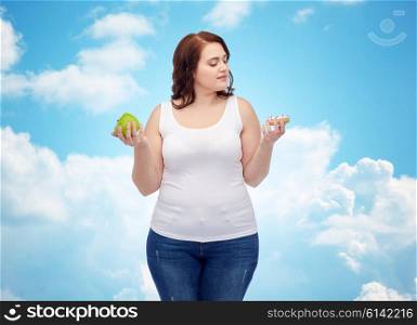 healthy eating, junk food, diet and choice people concept - plus size woman choosing between apple and cookie over blue sky and clouds background