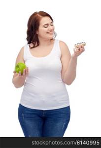 healthy eating, junk food, diet and choice people concept - smiling plus size woman choosing between apple and cookie