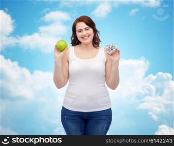healthy eating, junk food, diet and choice people concept - smiling plus size woman choosing between apple and cookie over blue sky and clouds background