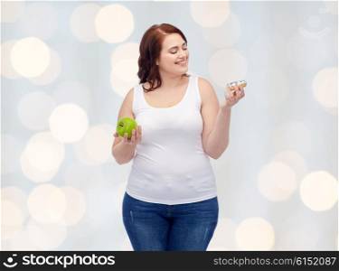 healthy eating, junk food, diet and choice people concept - smiling plus size woman choosing between apple and donut over holidays lights background