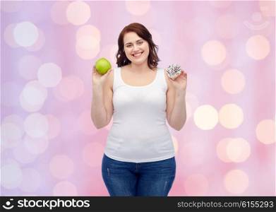 healthy eating, junk food, diet and choice people concept - smiling plus size woman choosing between apple and cookie over pink holidays lights background