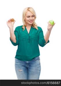 healthy eating, junk food, diet and choice people concept - smiling woman choosing between apple and cookie