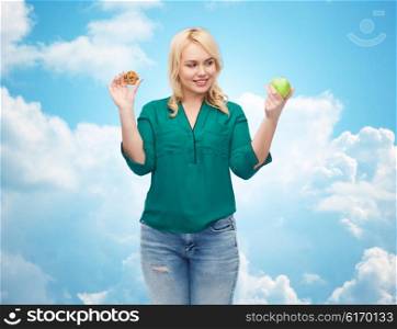 healthy eating, junk food, diet and choice people concept - smiling woman choosing between apple and cookie over blue sky and clouds background
