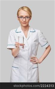 Healthy eating or lifestyle concept - female woman doctor holding and a glass of clear fresh water.. Healthy eating or lifestyle concept - female woman doctor holding and a glass of clear fresh water